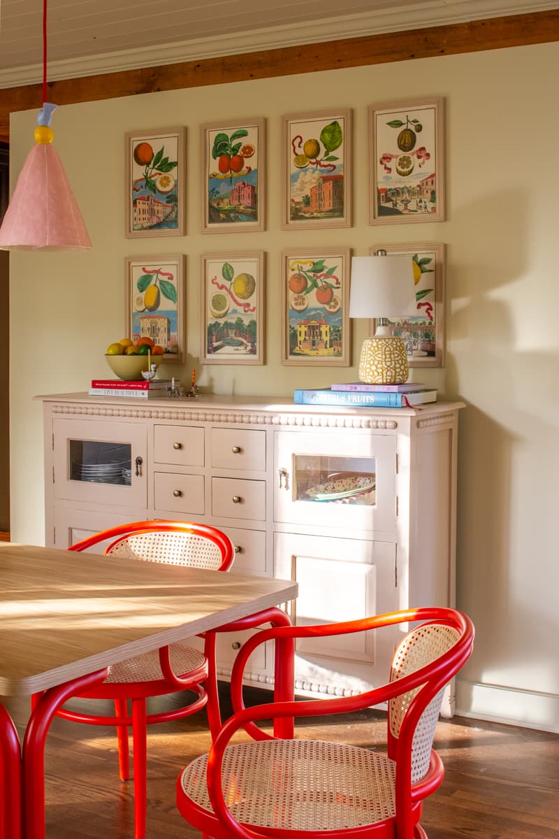 Dining room with red chairs and a pink buffet