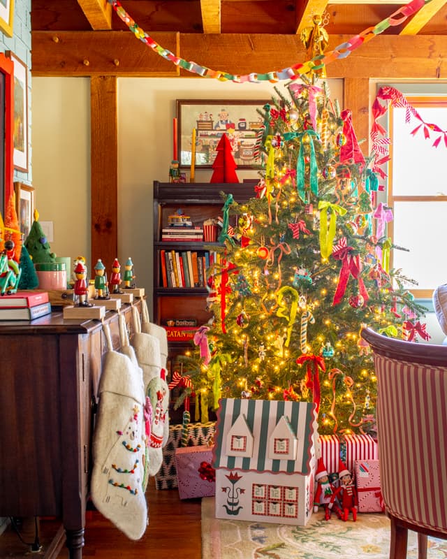 Christmas tree with colorful ribbon in a living room