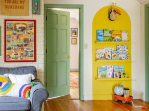 Colorful playroom with a yellow bookshelf and a gallery wall